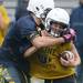 Saline High School football player looks to run the ball past a defender at the school on Monday, August 12, 2013. Melanie Maxwell | AnnArbor.com
